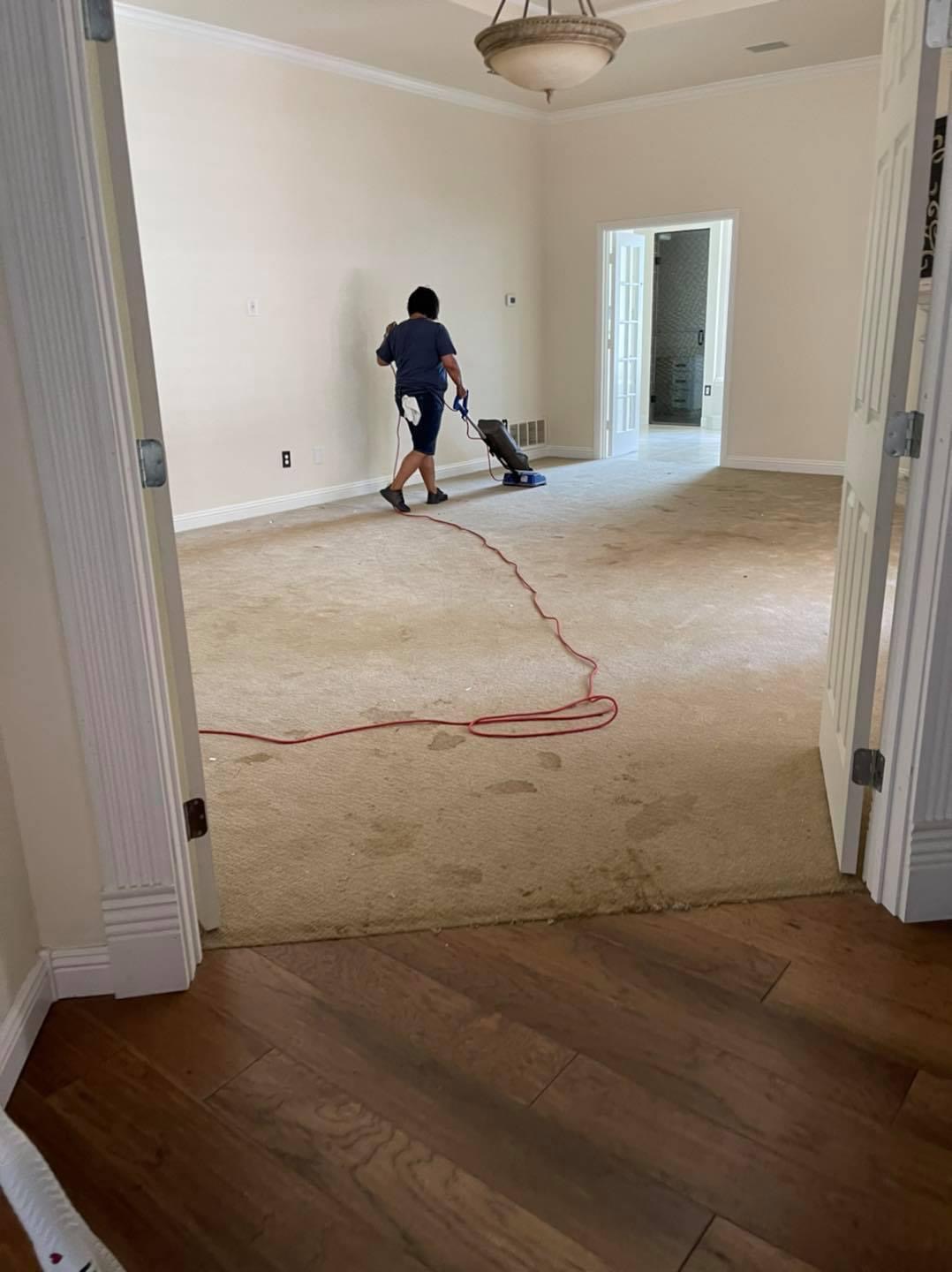 Vacuuming carpet in an empty home