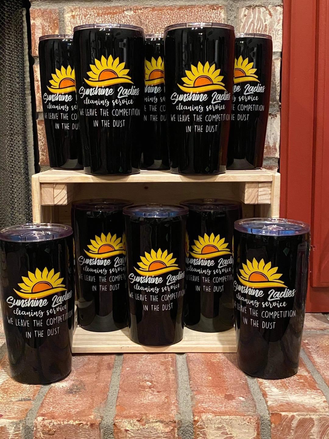 Sunshine Ladies branded tumblers with the sunflower logo